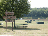 Photograph of the green grassy field area boarded with trees that is used as the Trap Field.