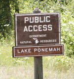 Single post brown wooden roadside sign that reads, "Public Access Lake Ponemah"