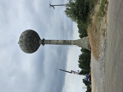 Picture of the water tower being built. The top holding tank now in place on the top. 